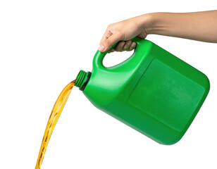 A green jug is being poured, releasing a stream of yellow liquid.