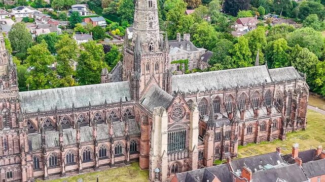 A close in rotating aerial view of the cathedral in the town of Lichfield, UK in summertime