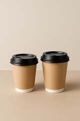 Double Delight: Two takeout coffee cups in perfect pairing, offering a visual treat with their sleek, minimalist design, ready to add warmth to any moment.