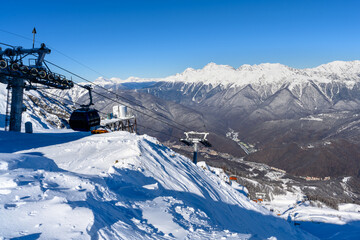 A view of snowy slopes from a cable car.