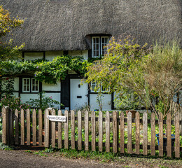 Traditional English village with thatched cottages.