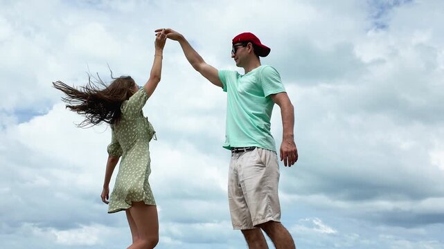 Happy caucasian couple having fun at the beach together. smiling beautiful young couple pending time together at the beach