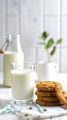 A glass of milk next to cookies on a table