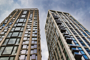 Two modern residential high-rise buildings with balconies  in London, UK.
