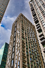 Fototapeta premium Tall Buildings with Glass Windows and Teal Facade in London, UK.