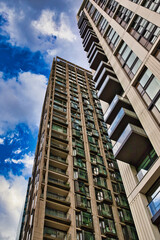 Two Modern High-Rise Apartment Buildings and Cloudy Sky  in London, UK.