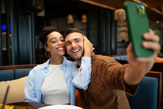 Happy couple shares a moment and a tasty meal at a charming outdoor eatery during their getaway