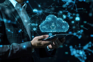 Businessman using a digital tablet with a holographic cloud network, symbolizing cloud computing and data connectivity.