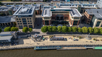 Aerial view of riverfront city with buildings and promenade  in Newcastle upon Tyne, UK.