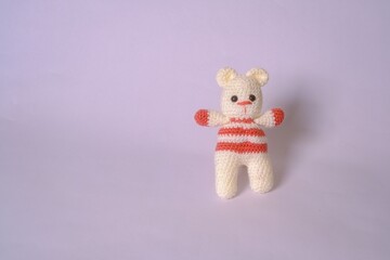Crocheted cream teddy bear.