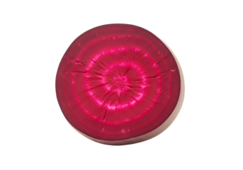 Vibrant crimson circle slice of a beetroot, showcasing intricate texture and a bold, intense color.