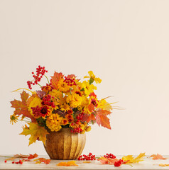 autumnal bouquet in ceramic vase on white background