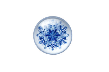 Circular, detailed snowflake design on a clear, round object