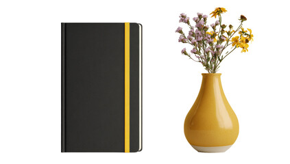 A dark gray notebook with a gold band sits beside a mustard yellow vase with wildflowers