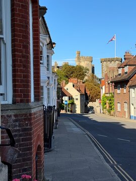 Empty city street with Arundel castle in the distance, Arundel, West Sussex, England, UK