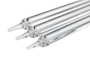 Close-up of three clear glass tubes, pointed ends,  interlocking