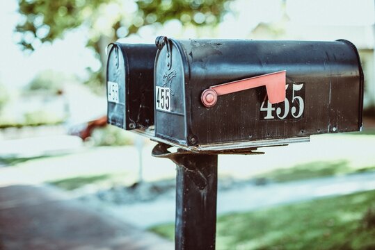 Close-up of two metal mailboxes side by side in a street, USA