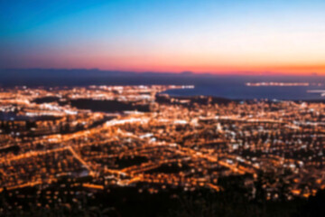 Obraz premium The lights of the night city. Blurred background. Lanterns on the street. big city lights in the twilight evening with blurring. Colorful circles of light abstract. circular bokeh on blue horizon.