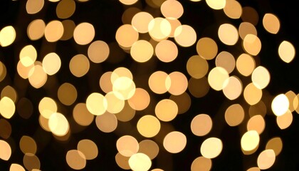 Abstract bokeh lights of golden hues on a black background