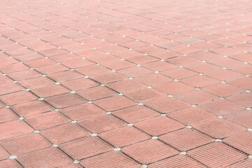 red interlocking pavement tile pattern with diagonal grooves background