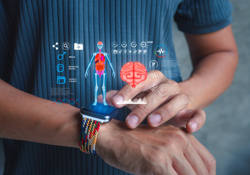 Man using a smartwatch with holographic projection of human body and brain. Concept of AI healthcare, smart wearable technology, and medical innovation.