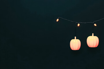 Dark background with glowing jack o lanterns shining with spooky halloween charm