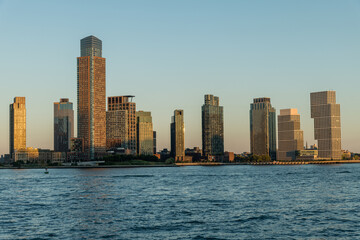 Fototapeta premium Scenic Long Island City waterfront vista taken from Manhattan across the East River at sunset in summer, Queens, New York City 