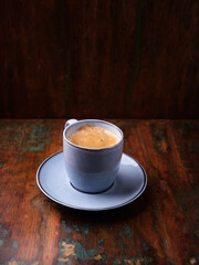 Cup of coffee on rustic wooden background. Soft focus. Copy space	
