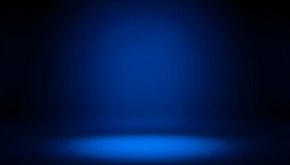 Obraz premium A dark blue studio background with a bright spotlight on the floor, creating an atmospheric and moody scene.
