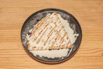 Chocolate crepes filled with milk chocolate mousse and toasted hazelnuts, topped with a scoop of vanilla ice cream