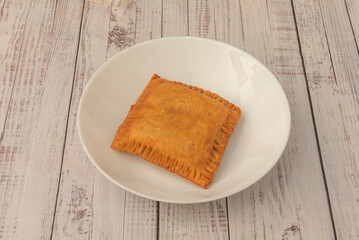 Golden and crispy fried empanadas filled with minced meat, tomato, onion, and bell pepper, served with homemade aioli and lemon