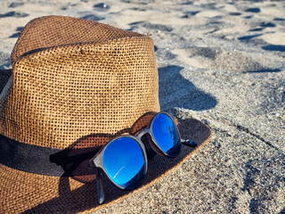 Travel, vacation, a hat and sunglasses on the beach