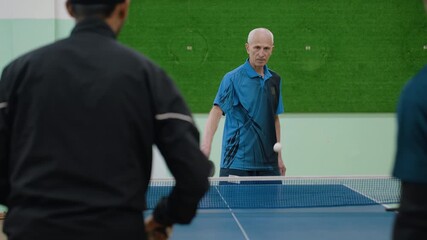 Close up back view of two athletes playing against senior coach during intense table tennis rally, one player misdirects shot into net while coach maintains focus in competitive indoor training match - Powered by Adobe