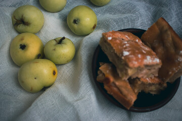 Apple pie with powdered sugar with green apples. Autumn dessert. Homemade dessert. Apple pie with cinnamon and fresh apple fruits. Country still life. Sweet dessert. Homely vibes. 