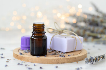 Lavender soap and essential oil with bokeh light background. Close-up. Wellness and aromatherapy concept.