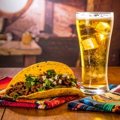 A taco and a beer on a table