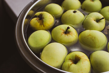 Fresh green apples in bowl. Ripe apples in water. Autumn harvest. Organic fruits background. Heap of green apples. Raw dieting. Natural vitamin. Healthy eating concept. Natural snack.
