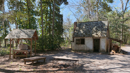 View of  two reconstructed colonial cabins, one of which is a traditional tabby structure with a wooden shingle roof,  Wormsloe State Historic Site, Savannah, Georgia, USA