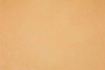 Old yellowed brown fabric surface with subtle abstract patterns