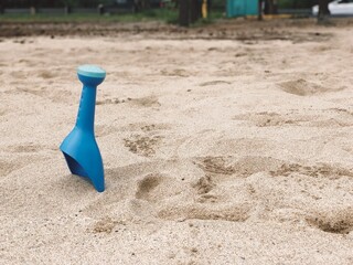 Colorful beach bucket and shovel toys on sand