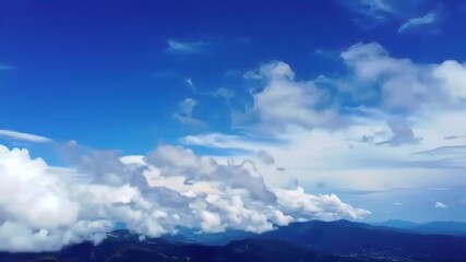 Mountain view over clouds in a blue sky background for inspirational quotes