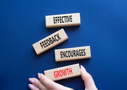 Feedback symbol. Wooden blocks with words Effective Feedback encourages growth. Businessman hand. Beautiful deep blue background. Business and Effective Feedback encourages growth concept. Copy space.