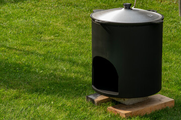 Тhe firebox for the cauldron stands on boards in the grass