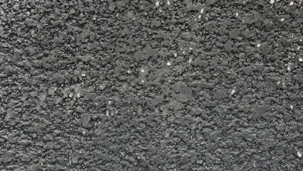 Rough black cement wall with stains and cracks. Fence texture. Background texture image.