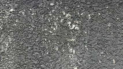 Rough black cement wall with stains and cracks. Fence texture. Background texture image.