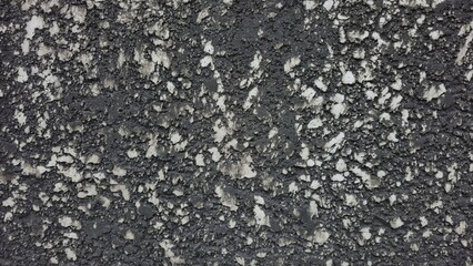 Rough black cement wall with stains and cracks. Fence texture. Background texture image.