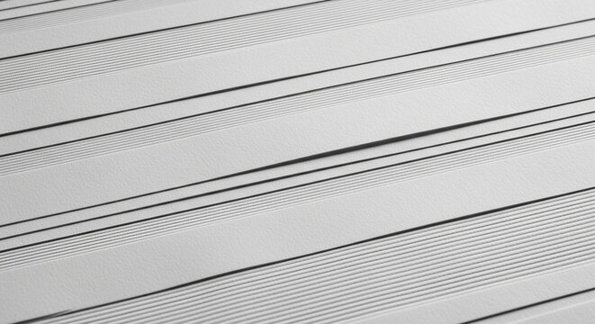 Close-up view of parallel lines and patterns on a light gray surface.
