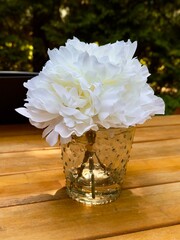 White peony bouquet in clear hobnail glass vase on wooden table outdoors, natural sunlight and garden bokeh, clean copy space, ideal hero banner background for wedding decor, lifestyle and ads