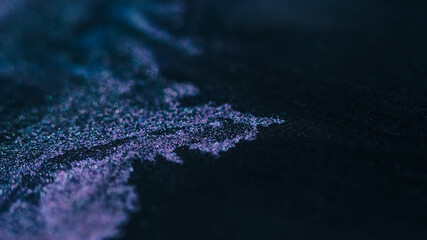 Blur fluid wave. Sparkling background. Defocused purple black color shiny wet paint shimmer water liquid flow on dark abstraction.