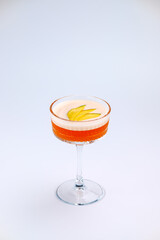 A sophisticated cocktail presented in a clear stemmed glass with garnished fresh fruit. The scene exudes elegance and refinement, perfect for luxury dining, celebrations, or social gatherings.